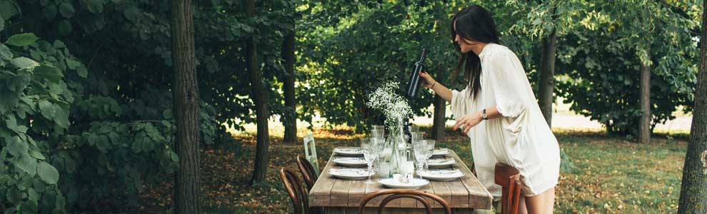 girl in park setting up an outdoor dinner table