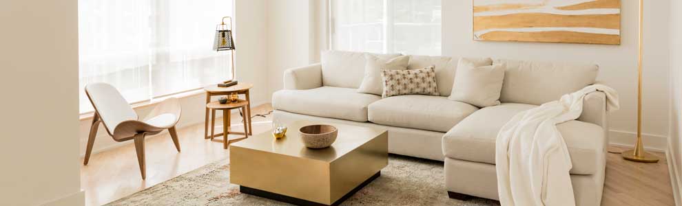 bright gold and beige living room with wood and linen furniture