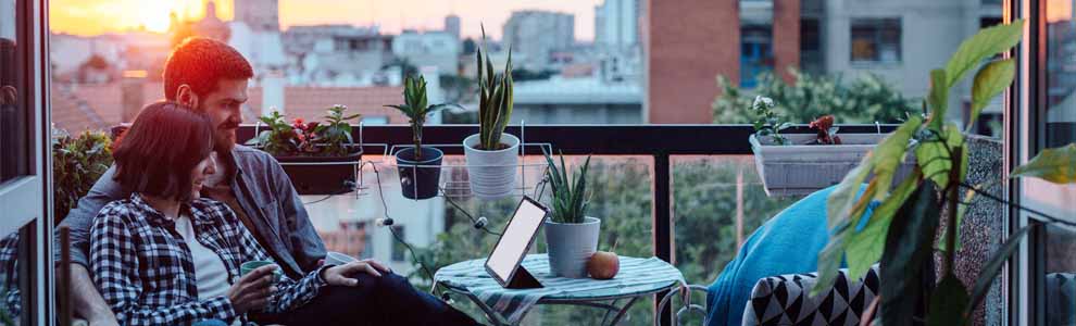 young couple sitting on their small balcony