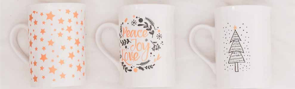 three mugs in a row with holiday sayings on them