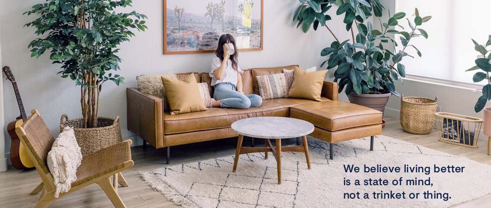 girl sitting in bohemian living room sipping from a mug