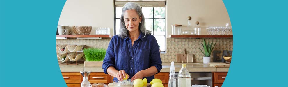 woman in kitchen slicing lemons for cleaning