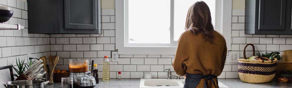 girl in black kitchen with reusable shopping bag