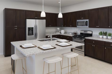 Kitchen includes granite countertops, brown cabinets and stainless steel appliances.