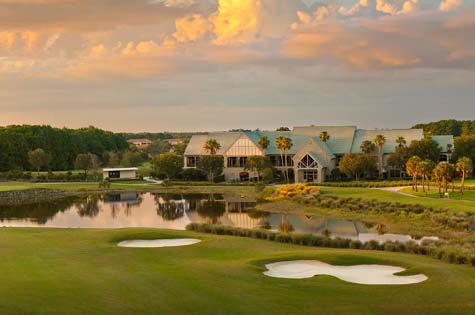 TwinEagles clubhouse exterior at sunset. Located in Naples