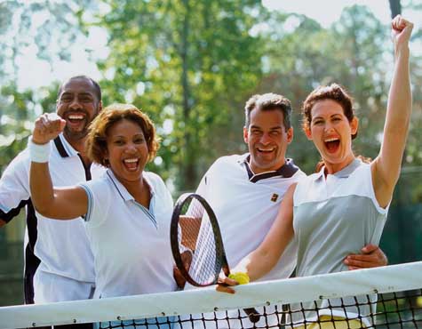 Couples playing tennis at Isles of Collier Preserve