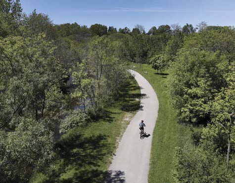 Biker on a trail in Mimco Creek, full of ravines and walking trails